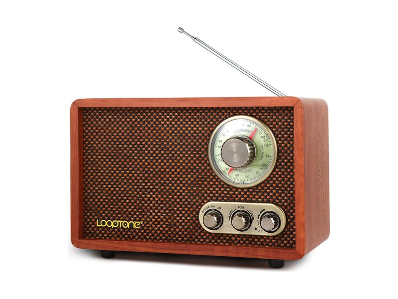 A retro-style wooden AM/FM radio with a tuning dial and three control knobs, photographed on white